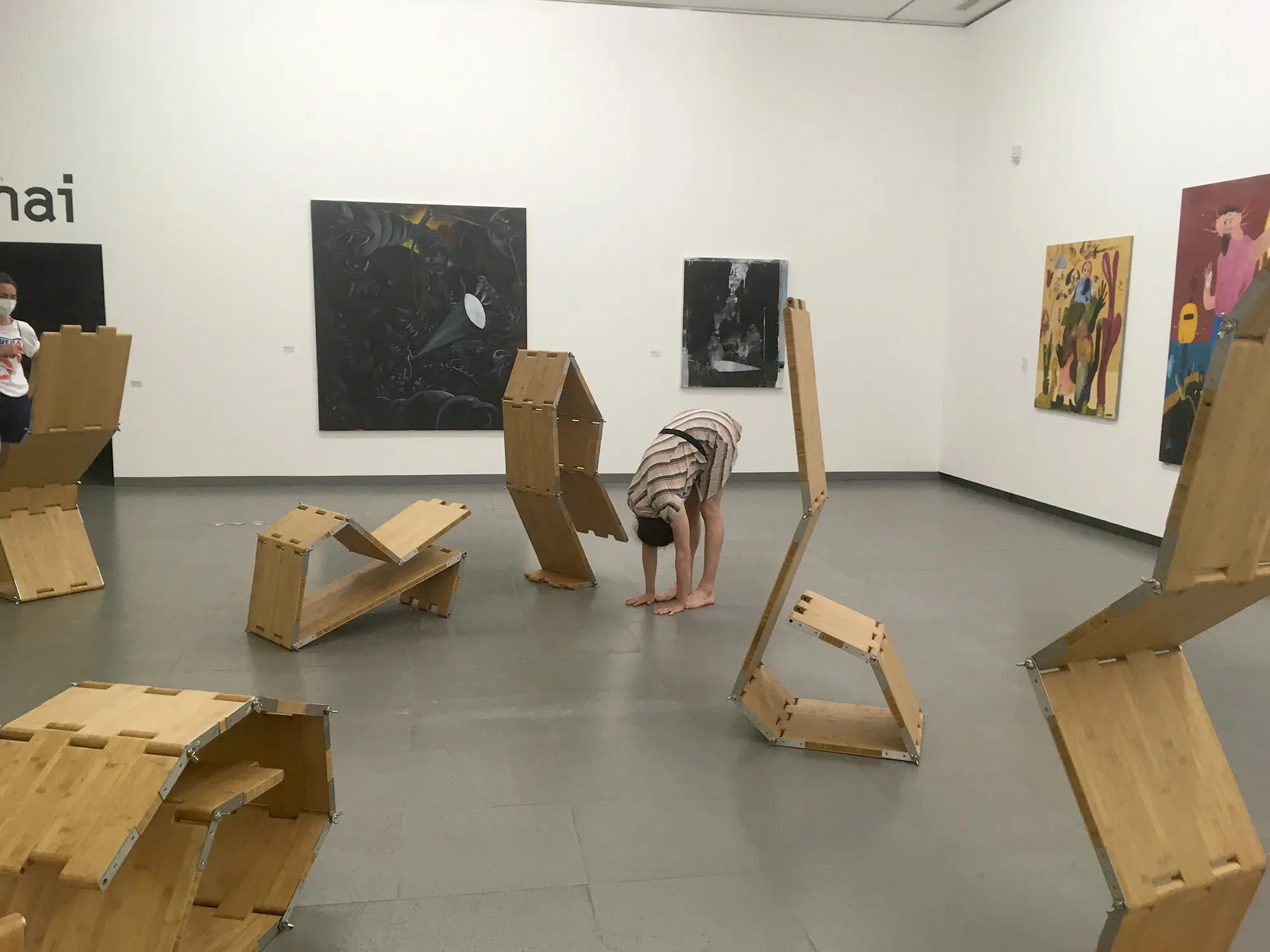 a person next to a group of sculptures, doing asana pose, imitating one of the sculptures